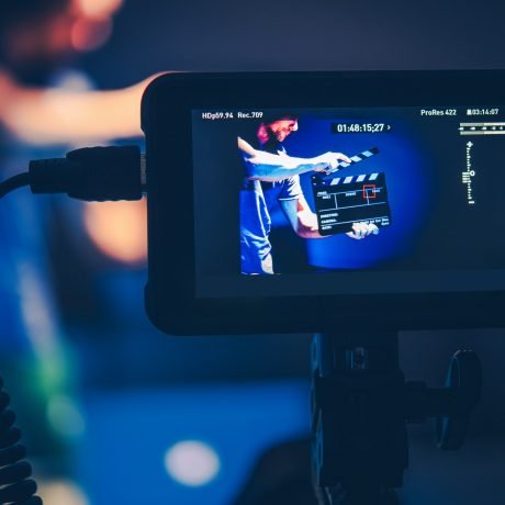 camera-operator-taking-shots-of-men-with-clapperboard.jpg